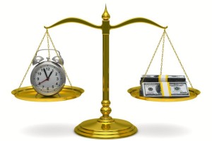 photo of clock and money on scale